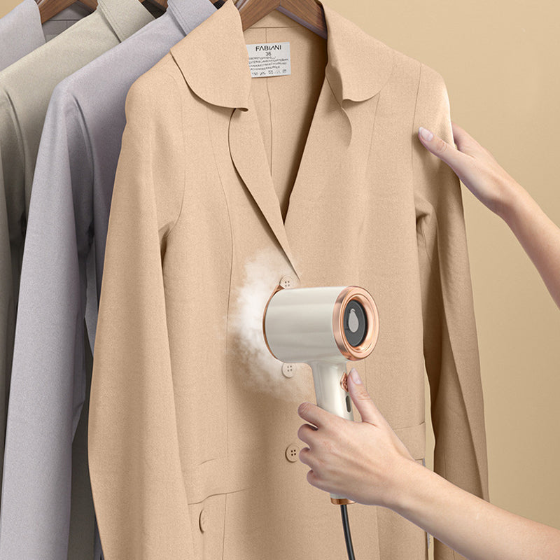 Travel-sized garment steamer and mini iron, packed neatly in a suitcase, a must-have travel gadget.