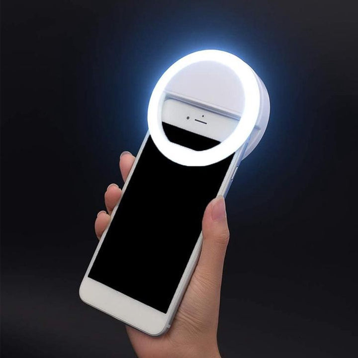 Portable LED selfie ring light with phone clip for smartphones, ideal for vlogging & content creation. USB rechargeable.