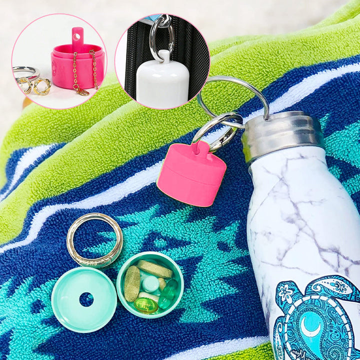 Compact travel pill case and jewelry holder on a keychain, shown with rings inside