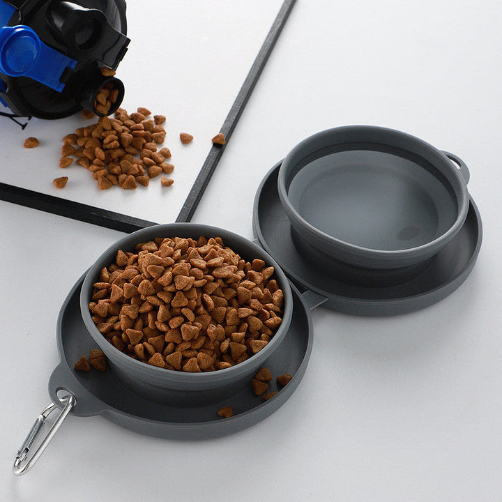 Hand holding folded blue silicone pet travel bowl set, demonstrating portability and compact size
