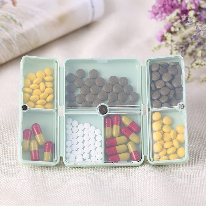 Compact 7-day pill box for travel, securing medication and vitamins with individual compartments
