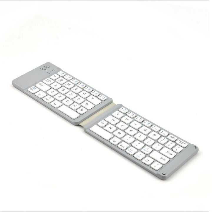 Folded portable Bluetooth keyboard with touchpad, fitting easily into a small bag or pocket