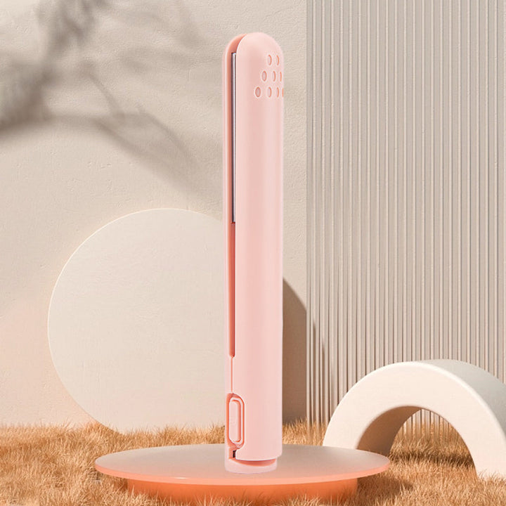 The mini hair straightener and curler neatly packed in a small pouch, highlighting its portability.