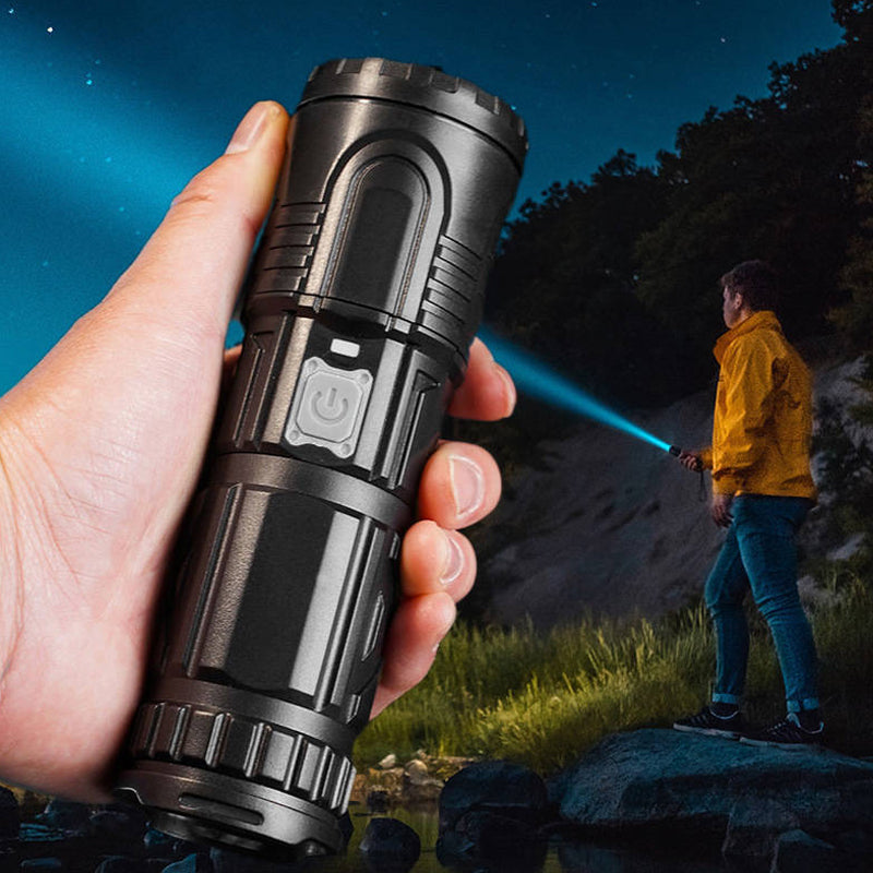 Rechargeable LED flashlight in hand, pointing upwards, signaling for emergency or guiding light