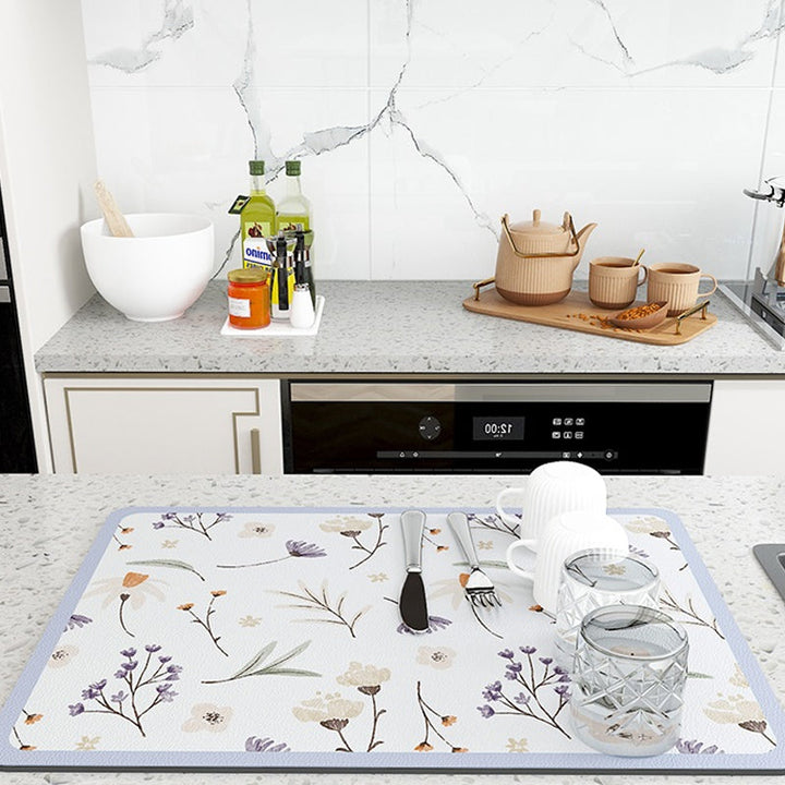 Beige diatomaceous earth kitchen mat, ideal for quick drying dishes and protecting counters.