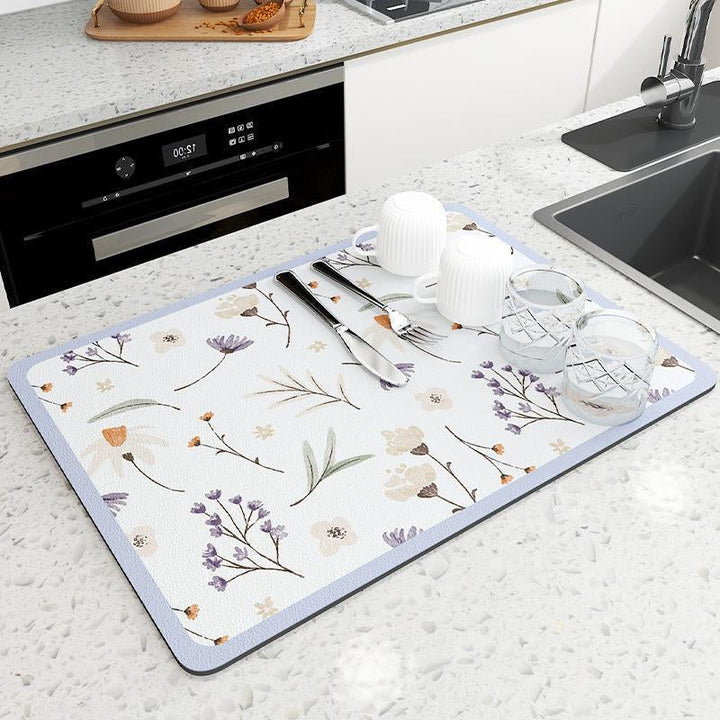 Modern kitchen decor featuring a quick-dry diatomaceous earth mat next to a sink.