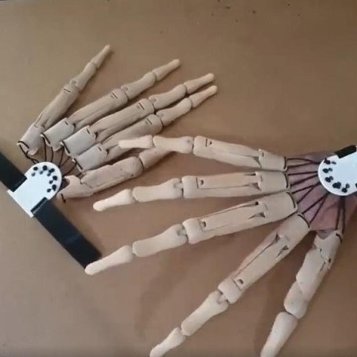Unisex Halloween skeleton hand gloves, featuring articulated fingers for a lifelike and eerie effect