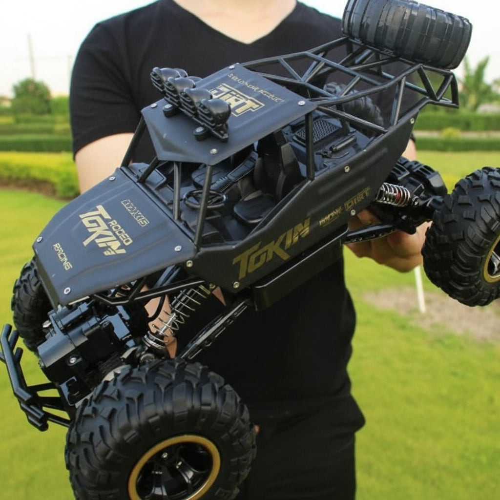 Red 4WD RC off-road monster truck conquering rocky terrain, remote control toy for kids and adults.
