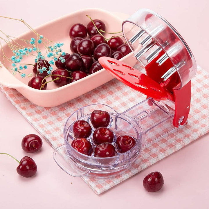 Red cherry pitter tool, 6-cherry capacity for efficient fruit prep in the kitchen.