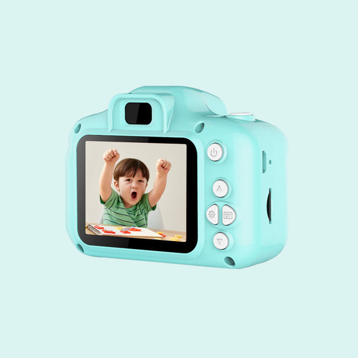 Front view of a blue kids' reusable mini digital camera, displaying its lens and flash for bright photos.