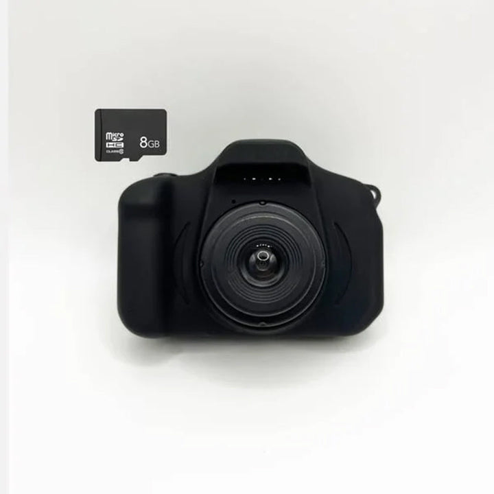 Toddler happily using a red kids' reusable mini digital camera, capturing a candid moment.