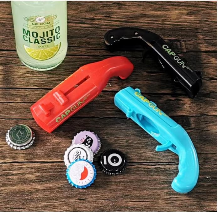 Red Novelty Cap Launcher Bottle Opener, fun gadget for parties, opens bottles and shoots caps.