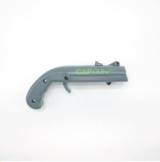 Novelty Cap Launcher Bottle Opener on a wooden bar top, a cool bar gadget.