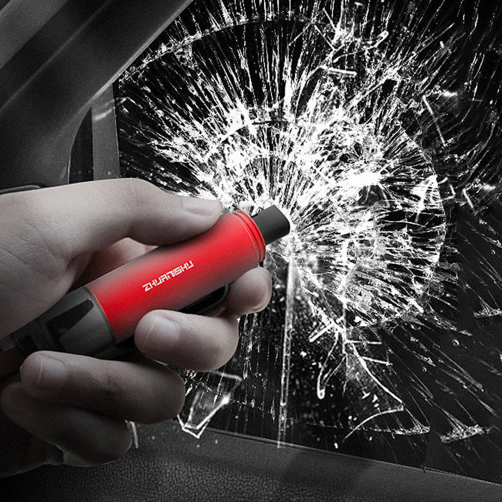 Close-up of a black vehicle emergency safety tool, featuring a sharp seat belt cutter blade