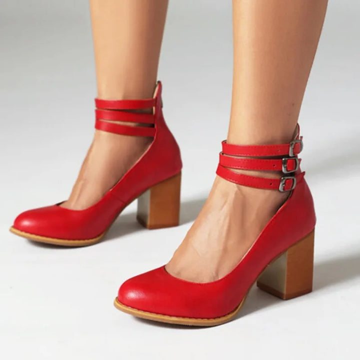 Women's triple strap block heel pumps in a studio shot, showcasing comfortable design