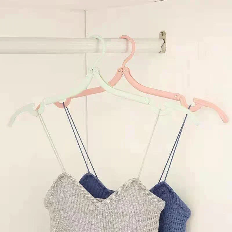 Retractable portable travel hanger extended, showing full size for hanging shirts and pants