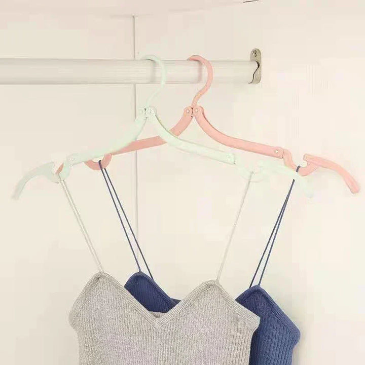 Retractable portable travel hanger extended, showing full size for hanging shirts and pants