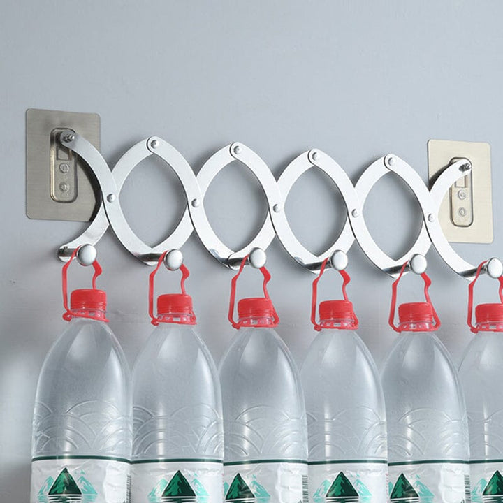 Chrome finish retractable hook rack fitting neatly over a door, perfect for home organization needs