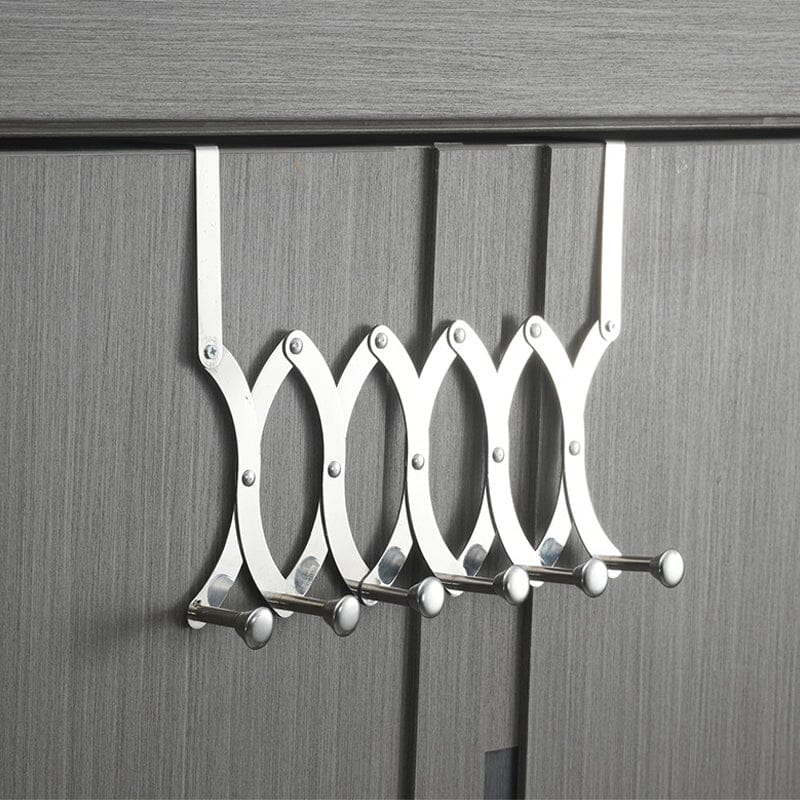 Lifestyle image of the retractable metal coat rack, organizing items in a modern home setting