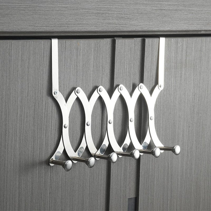 Lifestyle image of the retractable metal coat rack, organizing items in a modern home setting