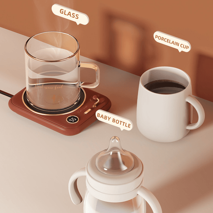 Compact USB mug warmer in white, warming a tea cup on a modern desk, perfect for home or office.