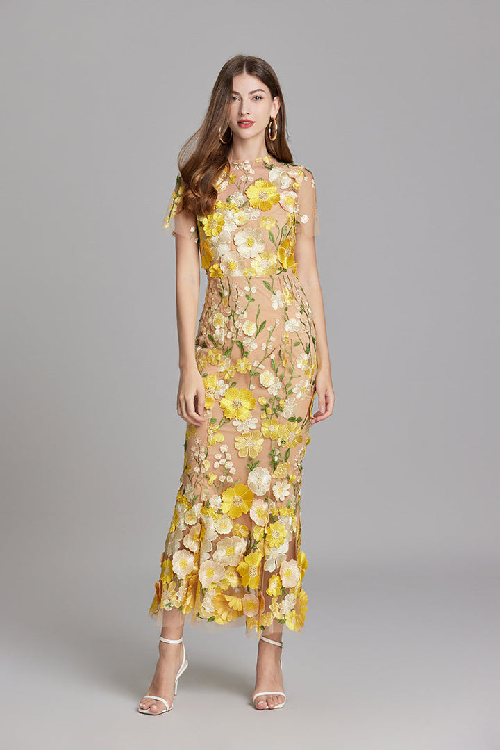 Women's illusion neckline mermaid evening gown with delicate floral appliqué.