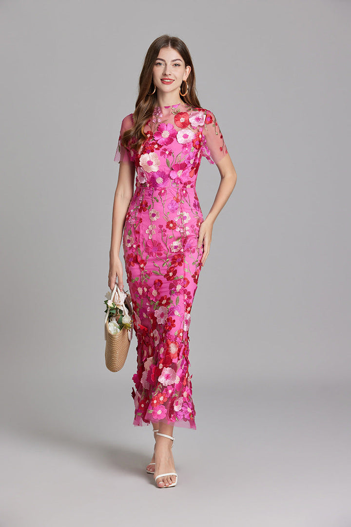 Elegant women's mermaid gown with intricate floral appliqué.