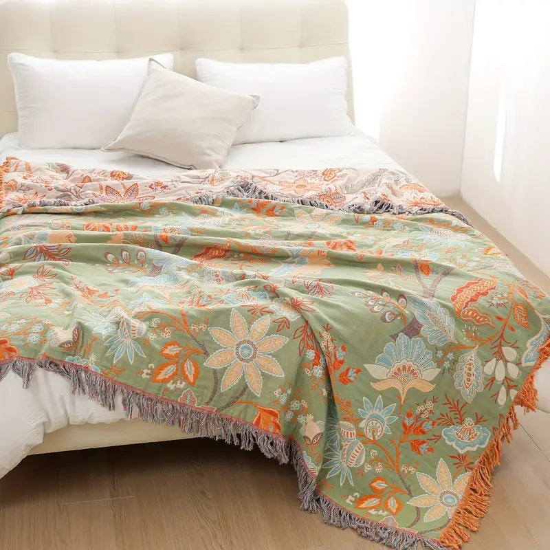 Decorative cotton blanket, featuring a rustic floral boho design for cozy spaces.