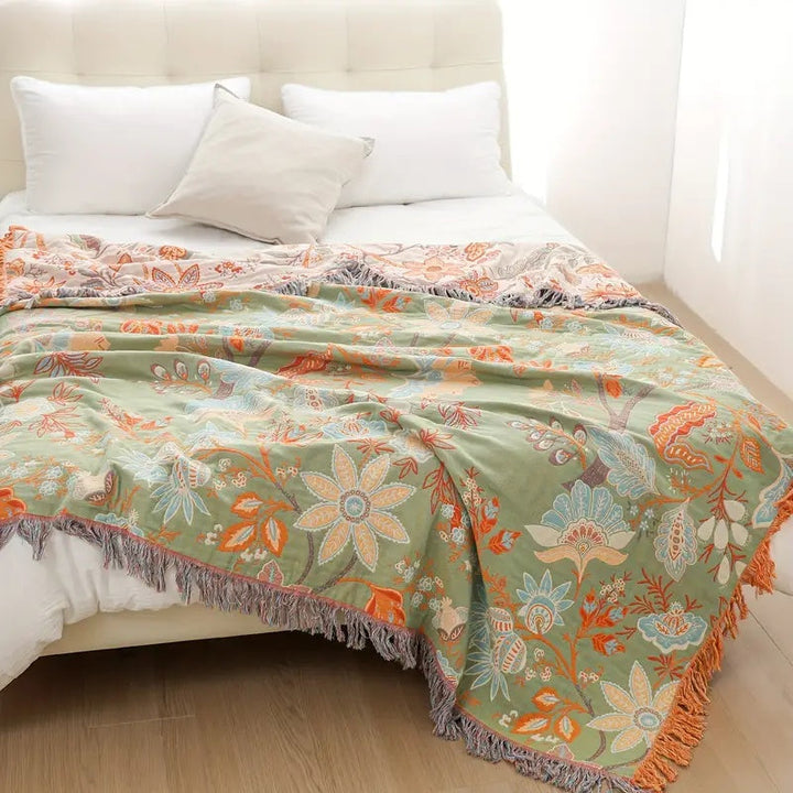Decorative cotton blanket, featuring a rustic floral boho design for cozy spaces.