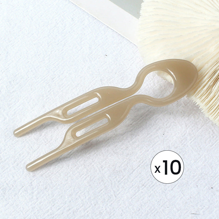 Various updo clips in a pile, showcasing the quantity and utility of the women's hair pins.