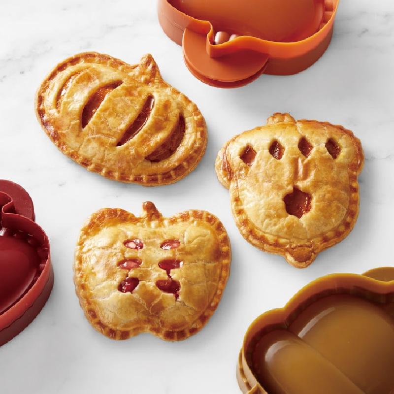 Kitchen baking tools set featuring three unique hand pie molds for various pastries.