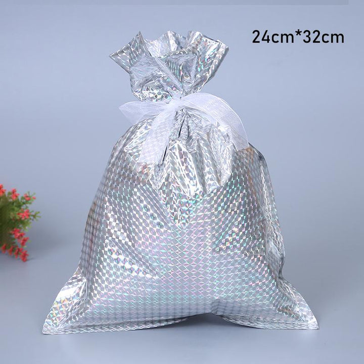 Group of friends exchanging gifts wrapped in festive reusable Christmas drawstring bags at a holiday party