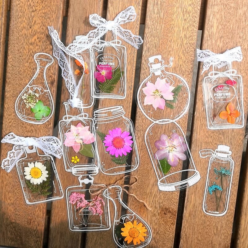 Collection of unique transparent bookmarks with different dried flowers, a thoughtful handmade gift idea.
