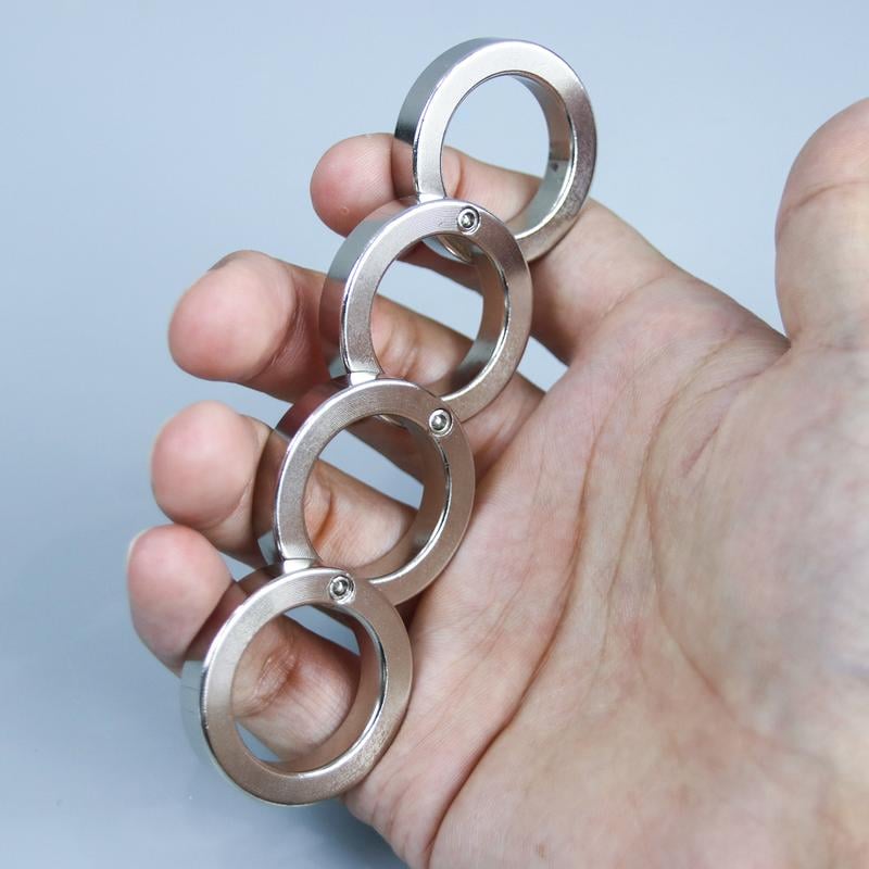 Portable folding four-finger fidget tool, designed for discrete stress relief and improved focus.