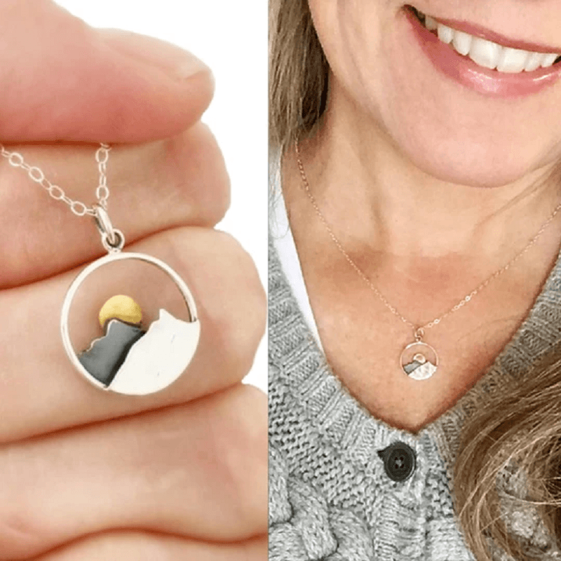 Close-up of a silver mountain landscape necklace, ideal gift for him or her, nature jewelry.