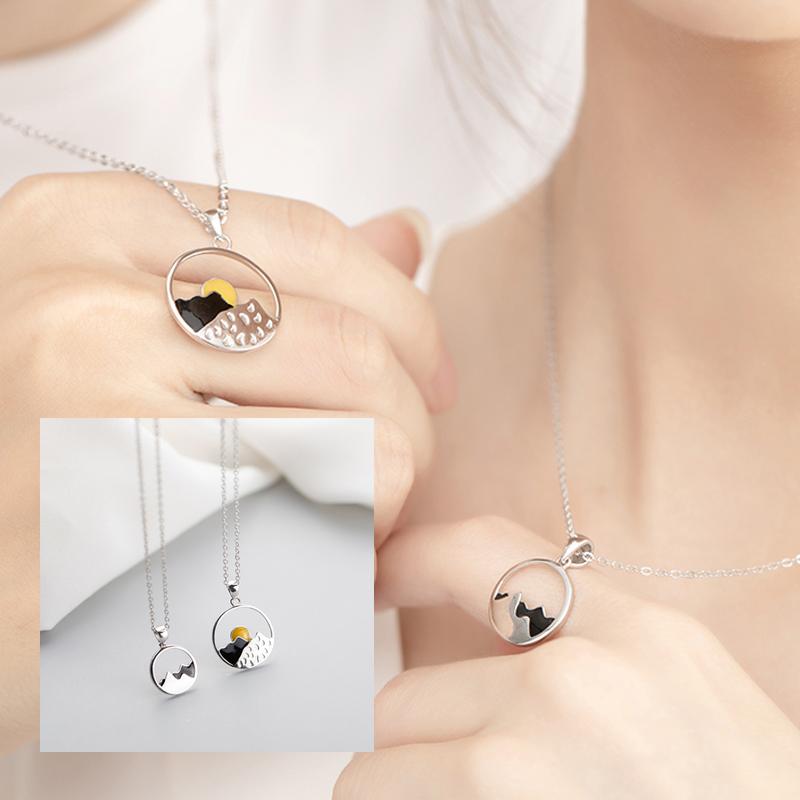 Detailed shot of a unisex alloy mountain necklace, a meaningful gift for nature lovers.