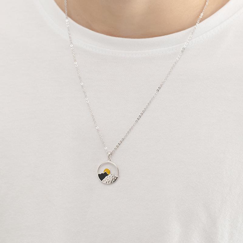 Matching silver mountain scenery necklaces, symbolic of shared outdoor adventures, couple's gift.