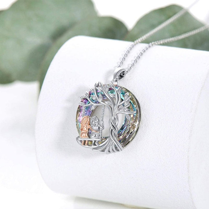 Women's silver necklace featuring a detailed Tree of Life and sister crystal