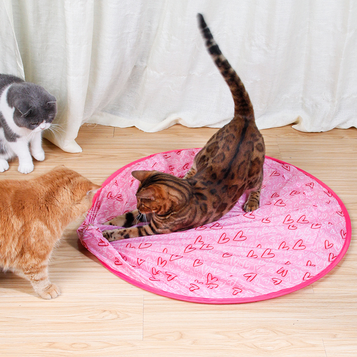 A hand holding the smart cat toy, illustrating its ergonomic size for easy handling.