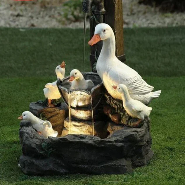 Solar duck & squirrel garden fountain with LED light, a charming weatherproof resin outdoor water feature for patio decor.