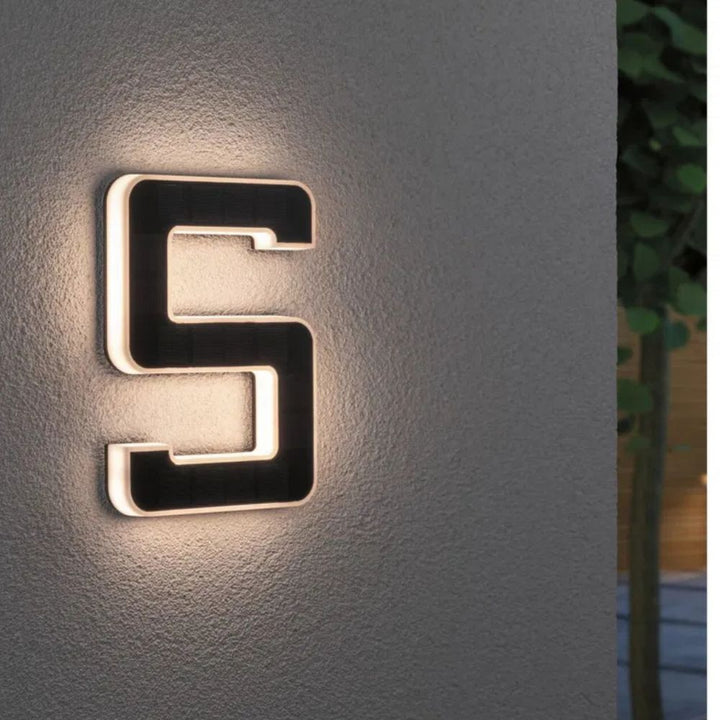 Close-up of a solar powered illuminated house number, showing clear digits.
