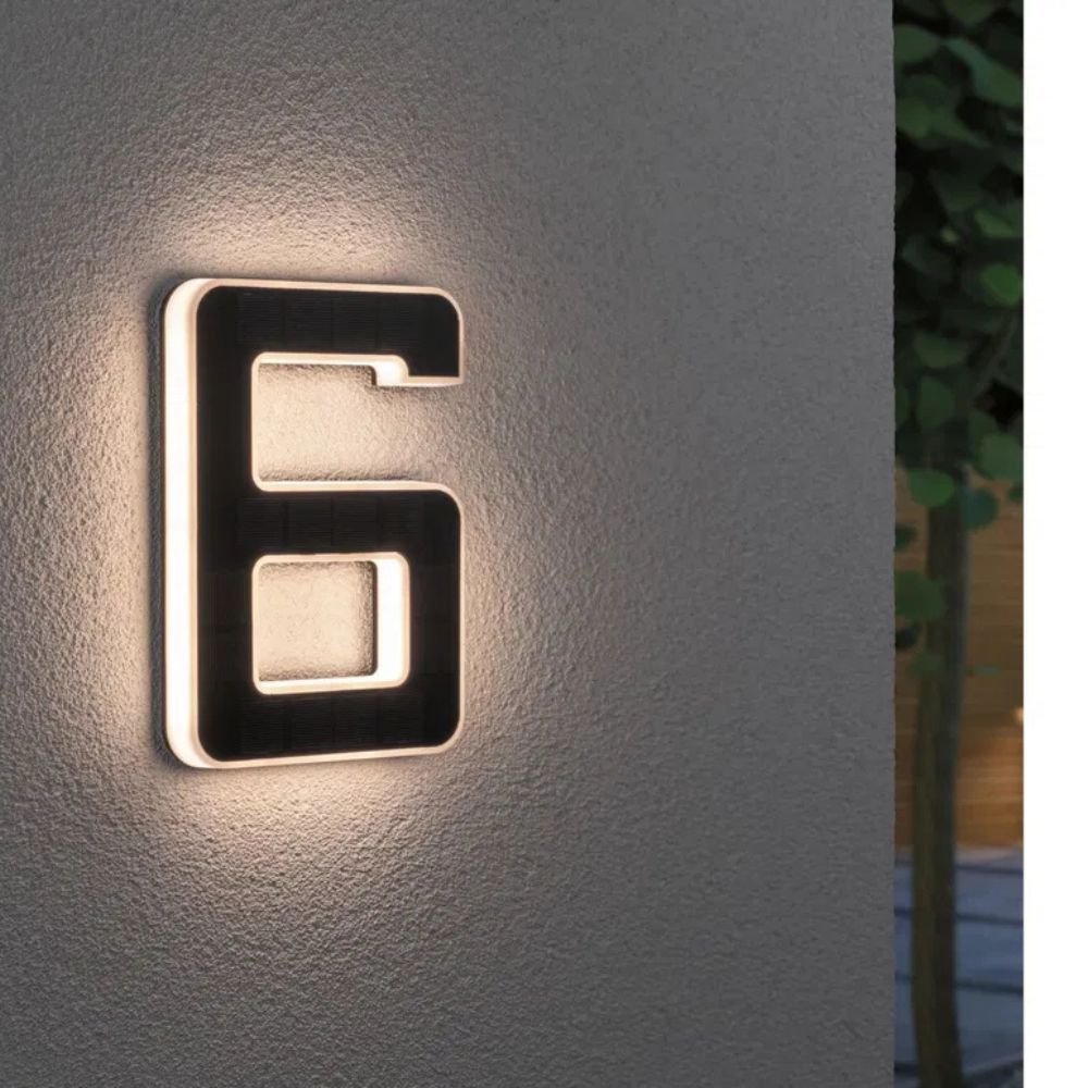 Weatherproof solar LED house number mounted on a wall, enhancing curb appeal.