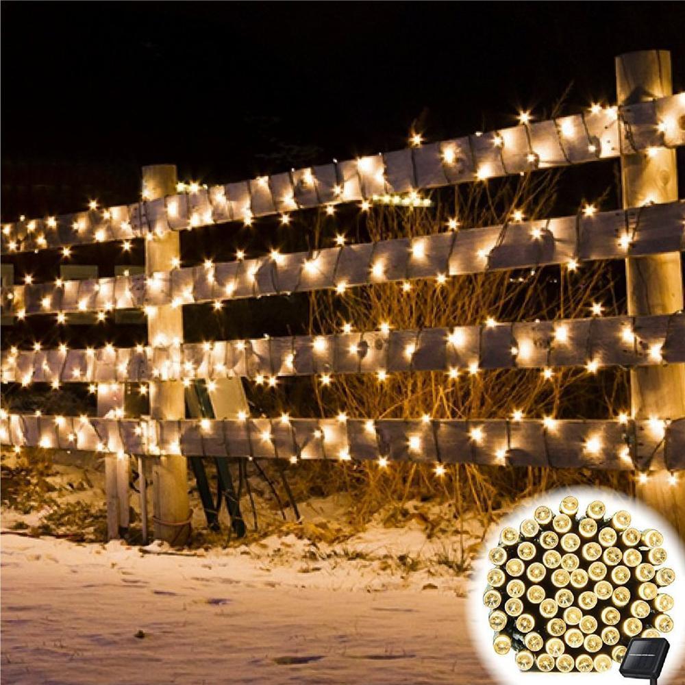 Solar-powered LED string lights in warm white, perfect for outdoor patio or garden decor, eco-friendly lighting.