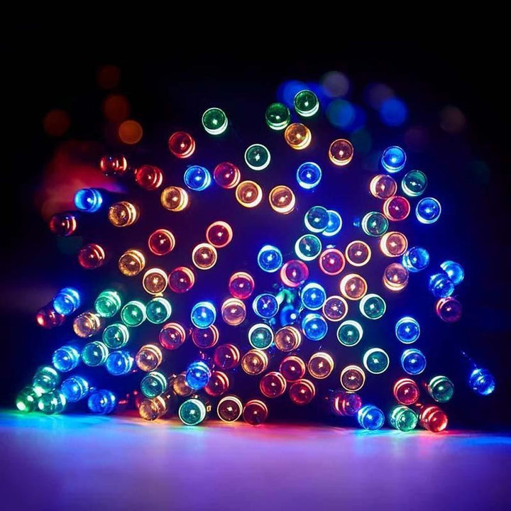 Detailed view of warm white LED string lights, powered by solar energy, for charming outdoor patio lighting.