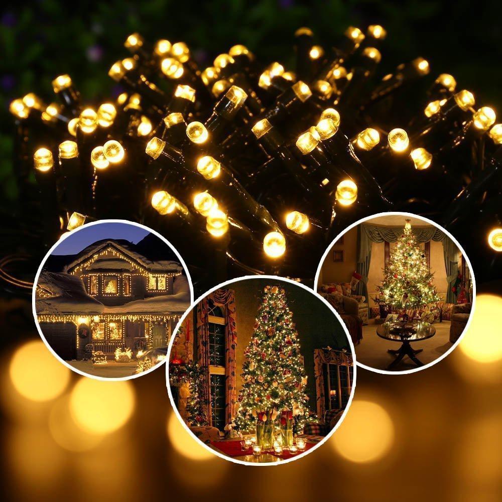 Solar garden lights, string design, draped around a tree for decorative multi-color outdoor illumination.