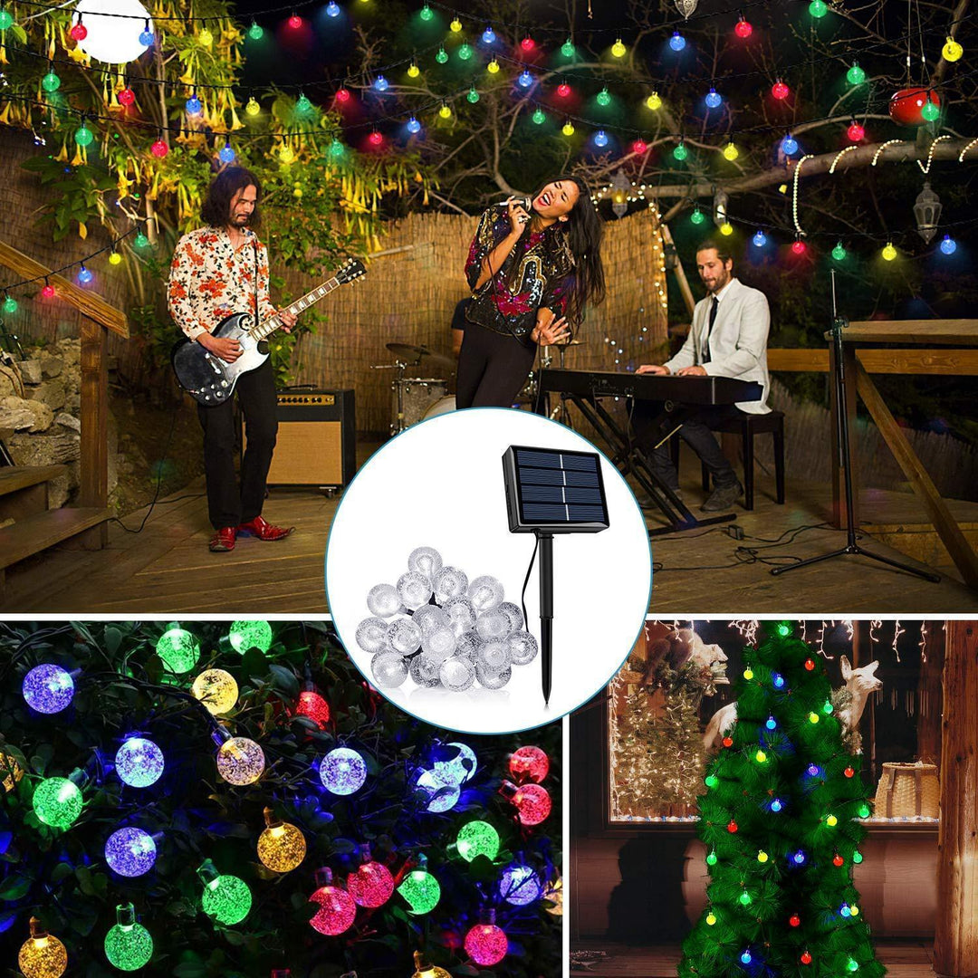 Solar powered outdoor LED string lights illuminating a patio, perfect for garden decor