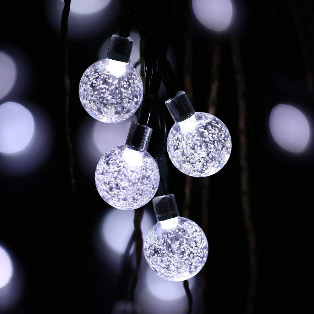 Solar powered outdoor string lights with a clear view of the attached solar charging panel
