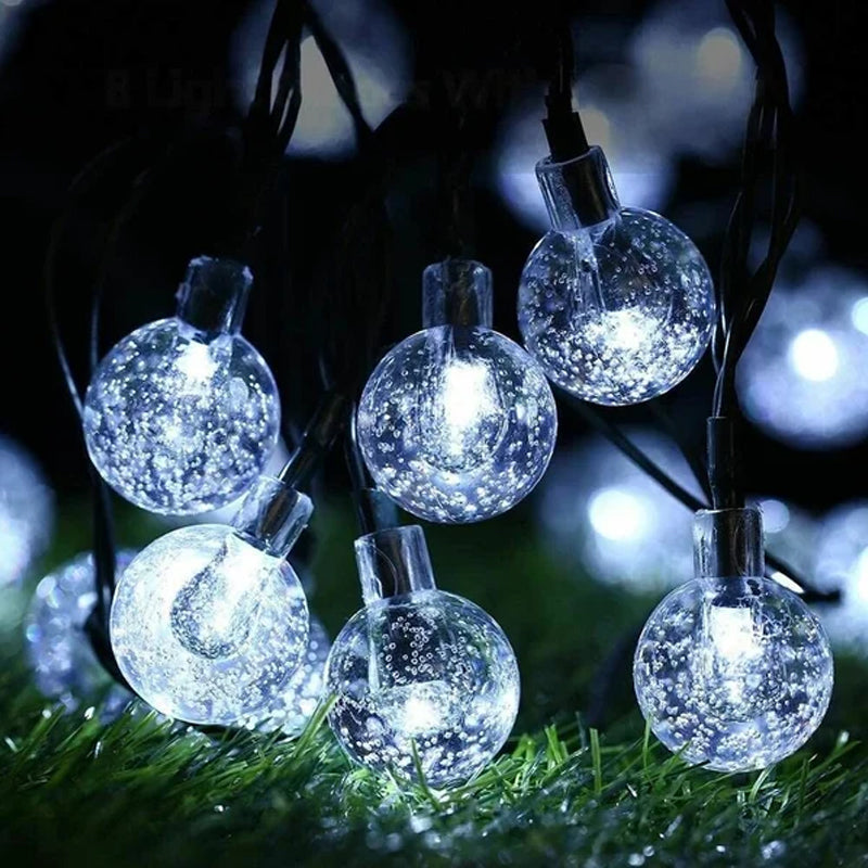 Bistro style solar string lights draped elegantly across an outdoor patio, energy-saving decor