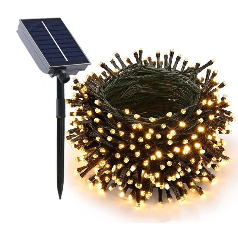 Solar panel charging outdoor string lights during the day, ready for night illumination
