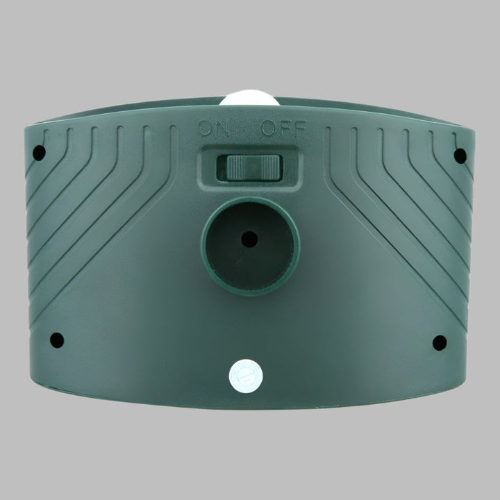 Wireless solar rabbit repeller installed in garden. Ultrasonic pest control device for yard defense, easy setup.